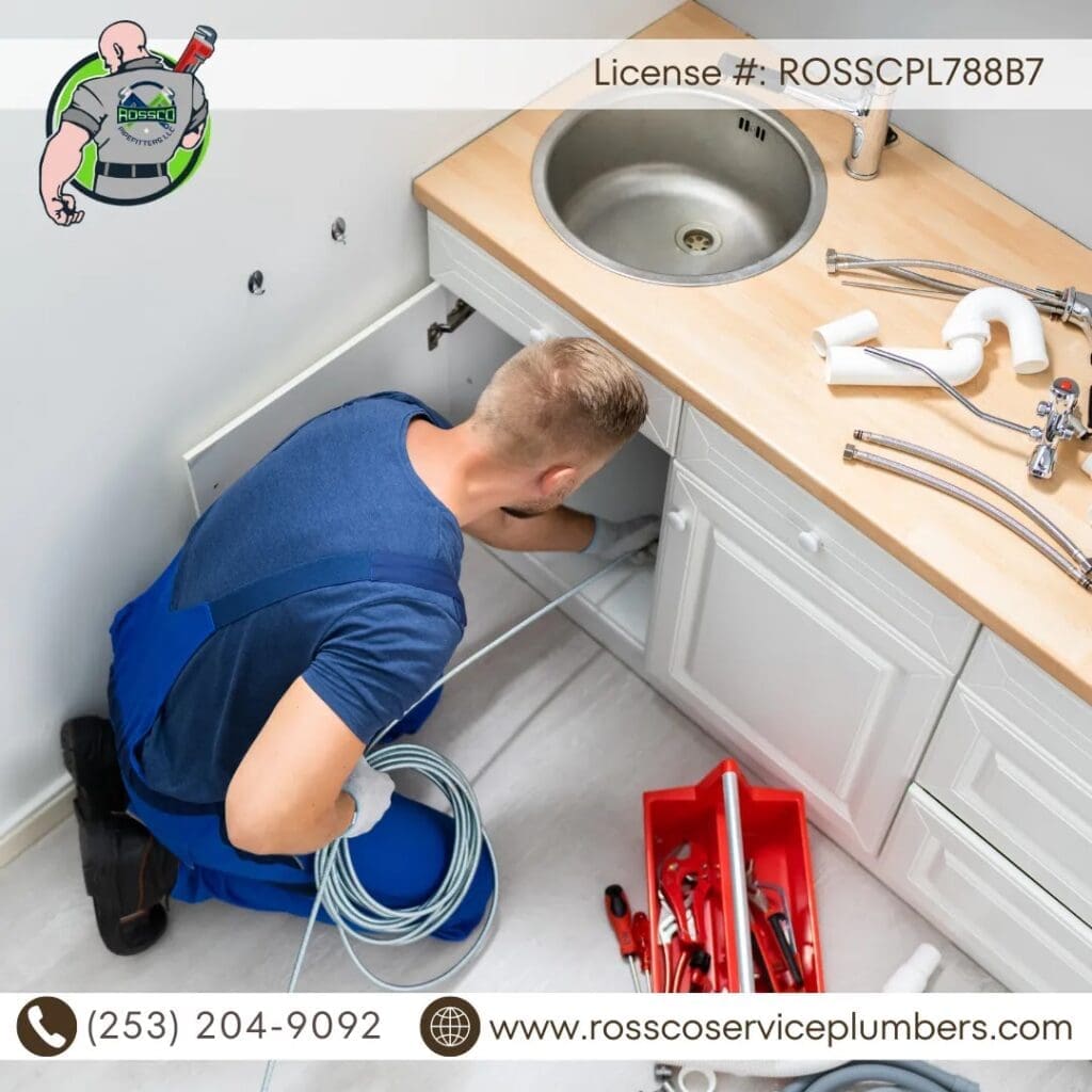 Plumber fixing under kitchen sink